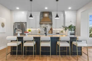 Contemporary kitchen on Summertime Circle with white cabinets, island barstools, pendant lights, and stainless appliances.